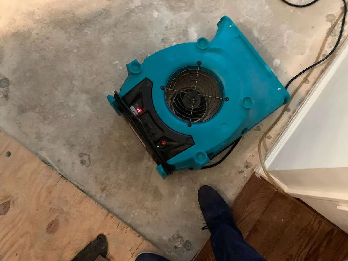 Air mover drying subfloor during Leak Detection & Repair in Dos Palos